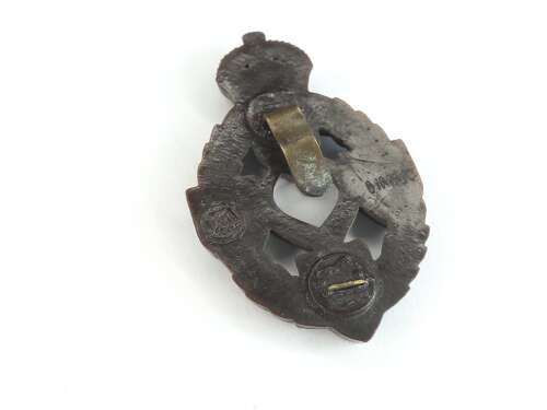 REME Plastic Cap Badge